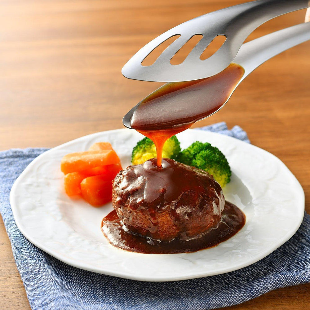 Japanese stainless steel flavoring tongs with slotted tip and curved ergonomic design for precise cooking and seasoning