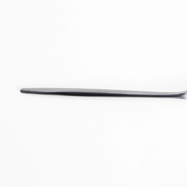 Long-handled stainless steel honey spoon with a uniquely shaped flat scoop