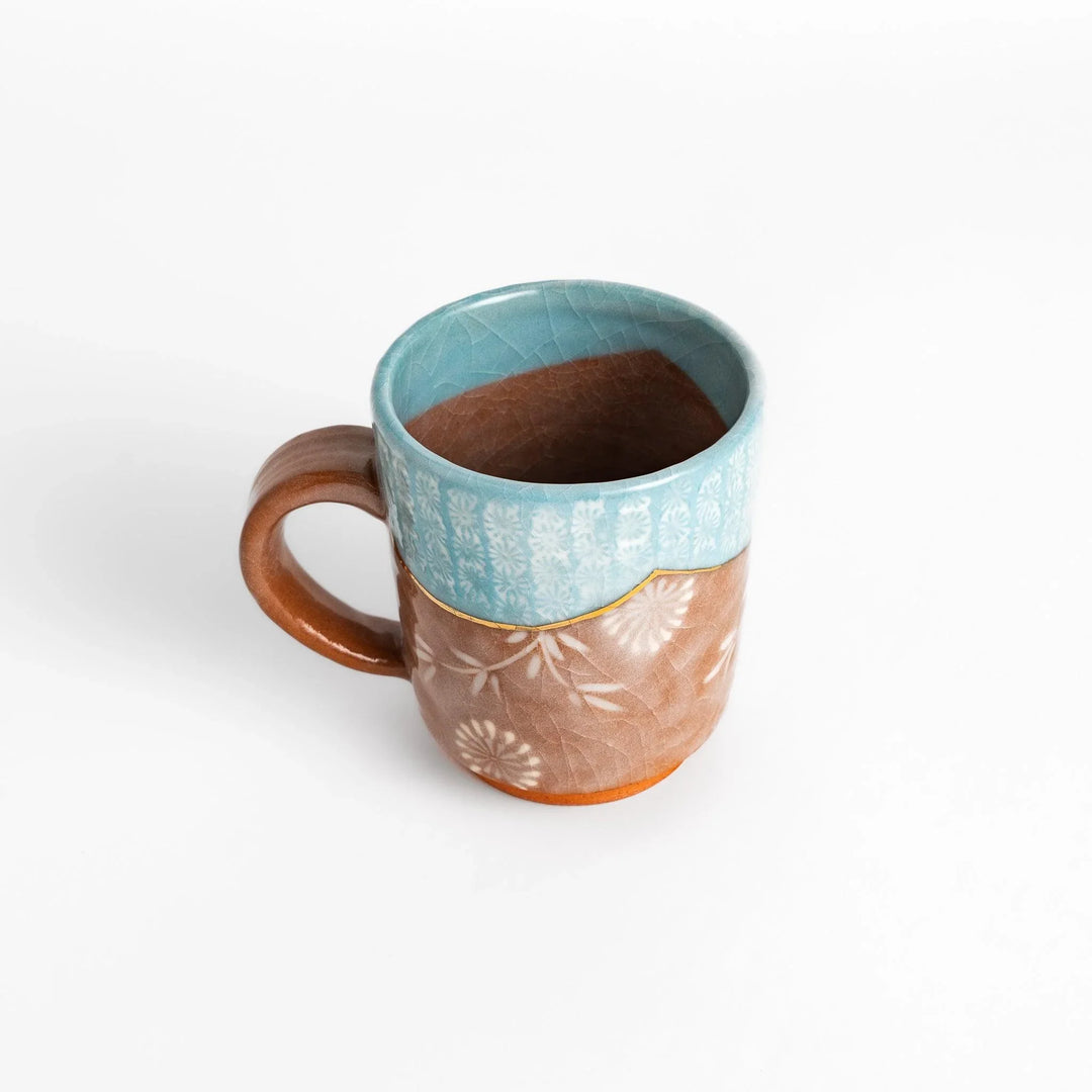 Blue floral mug with gold rim and delicate pattern, perfect for adding charm to your daily tea time.