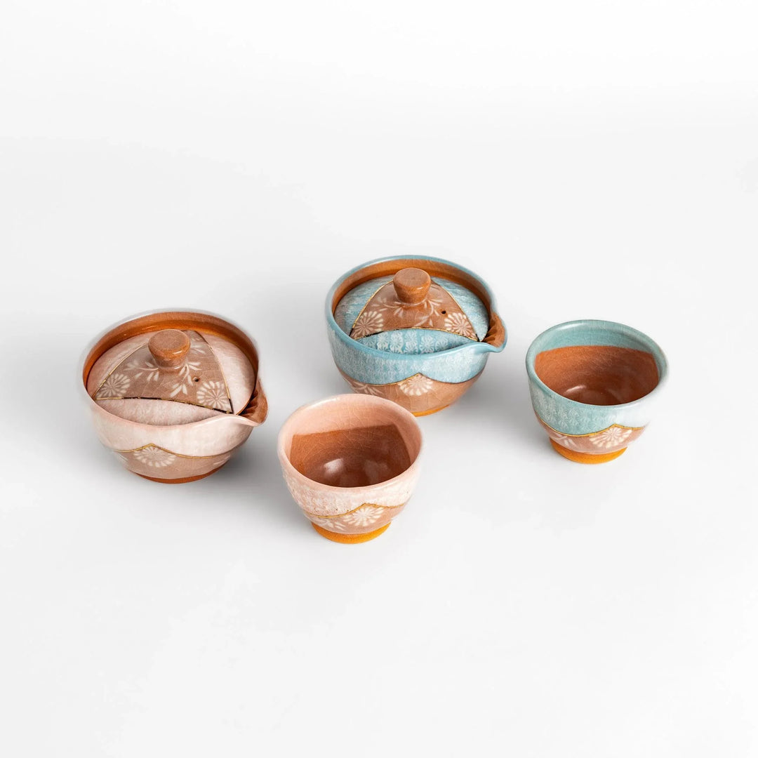 Exquisite tea set with hand-painted floral motifs on a porcelain teapot and cups, showcasing elegant Japanese craftsmanship.