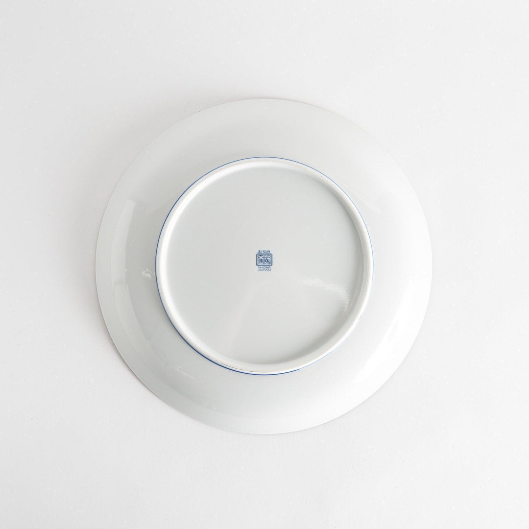 A round serving plate adorned with a detailed pattern of concentric blue dots creating a mesmerizing effect.