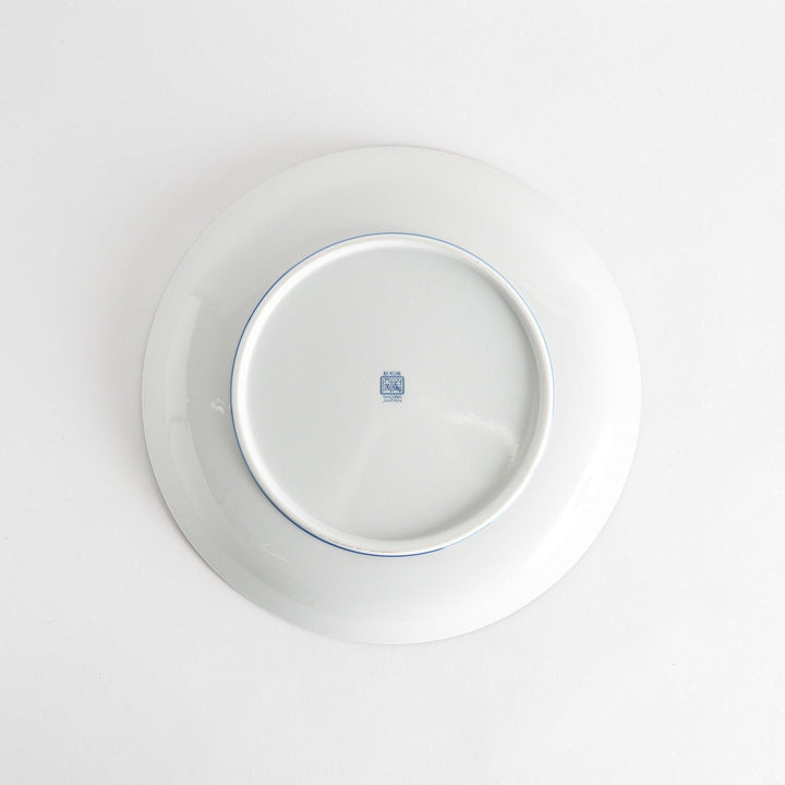 A round serving plate adorned with a detailed pattern of concentric blue dots creating a mesmerizing effect.