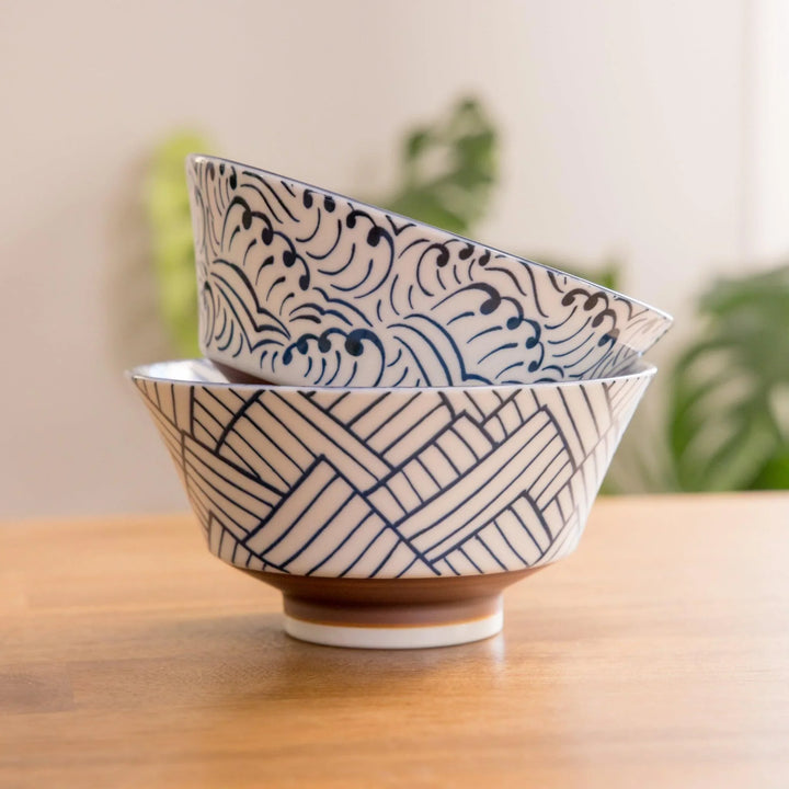 Stacked ceramic bowls featuring intricate blue wave and geometric patterns, designed with a subtle touch of elegance.