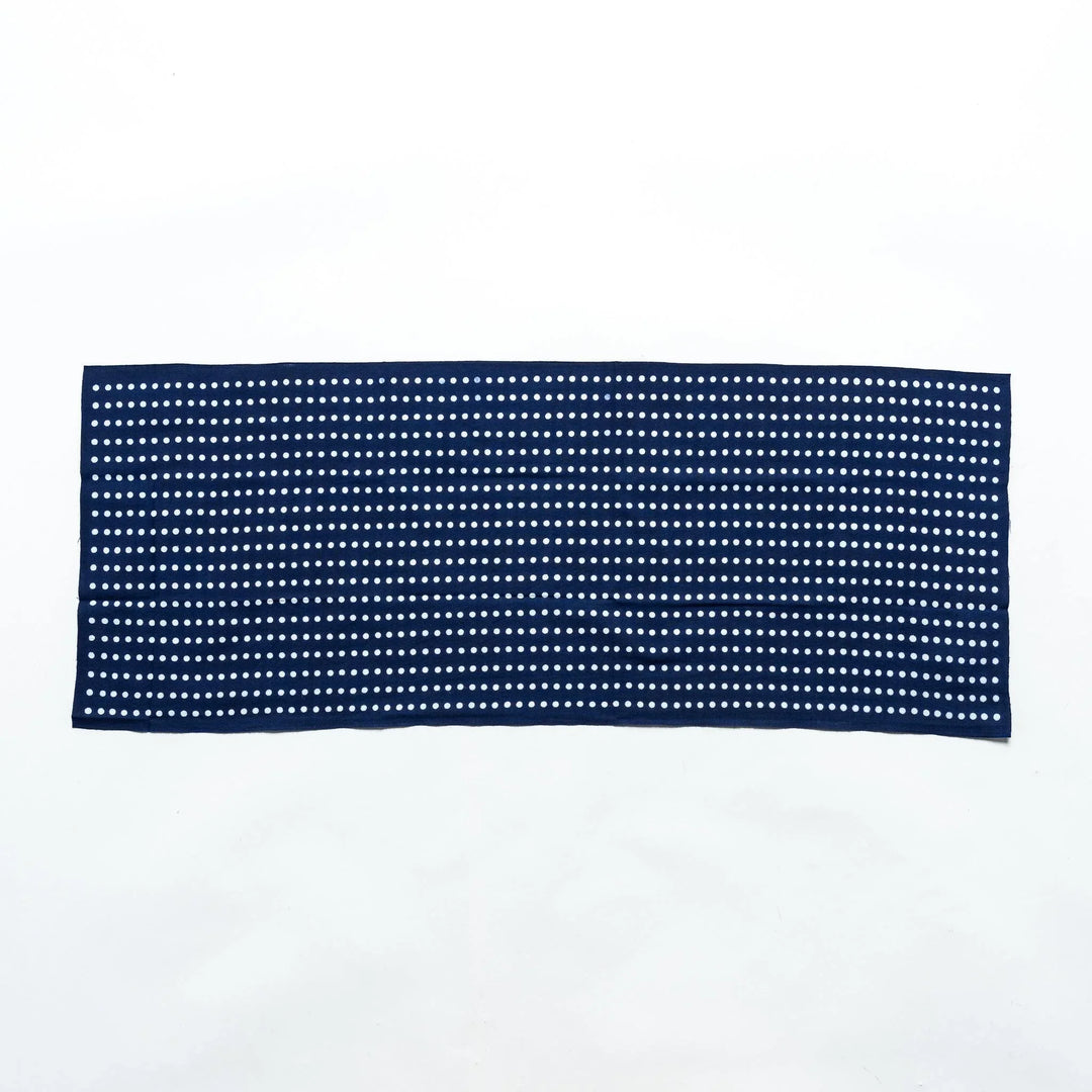 Navy tenugui fully laid out, featuring white bean dot patterns in rows.