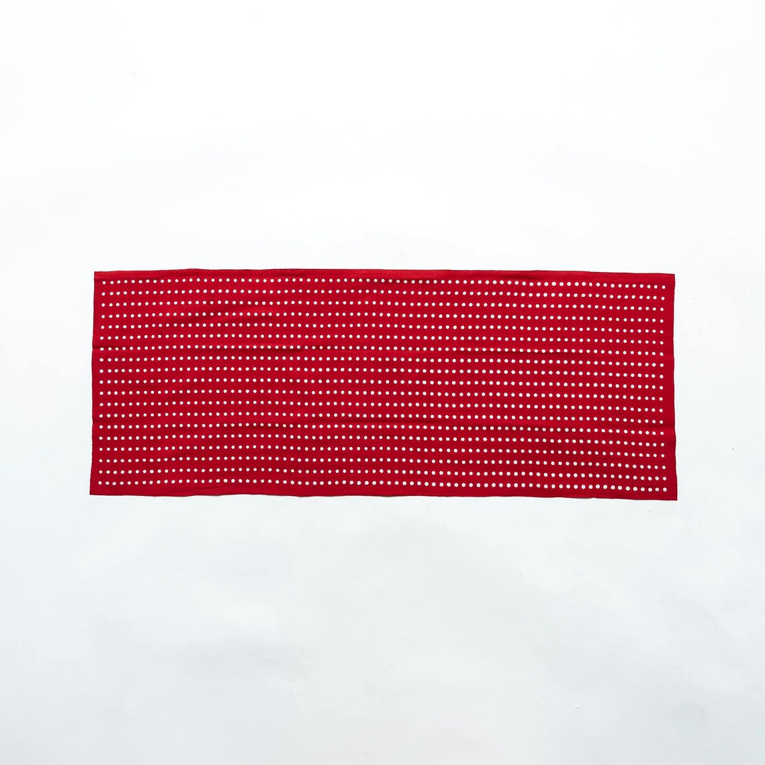 Red tenugui fully laid out, featuring white bean dot patterns in rows.