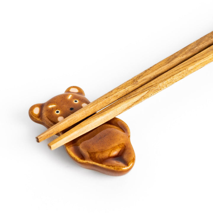 Bear-shaped chopstick rest, featuring a cute smiling face and playful design.