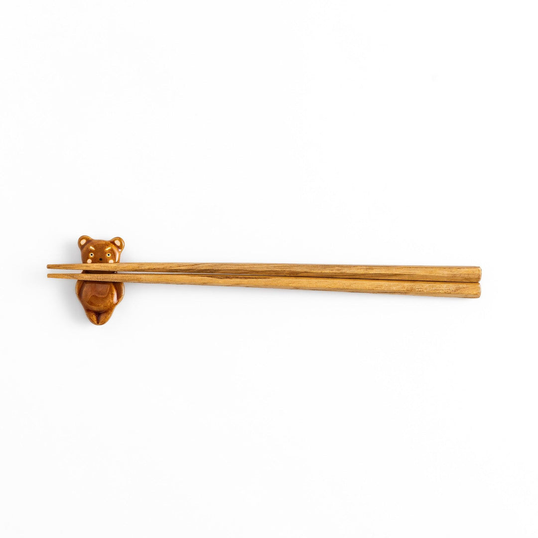 Bear-shaped chopstick rest, featuring a cute smiling face and playful design.