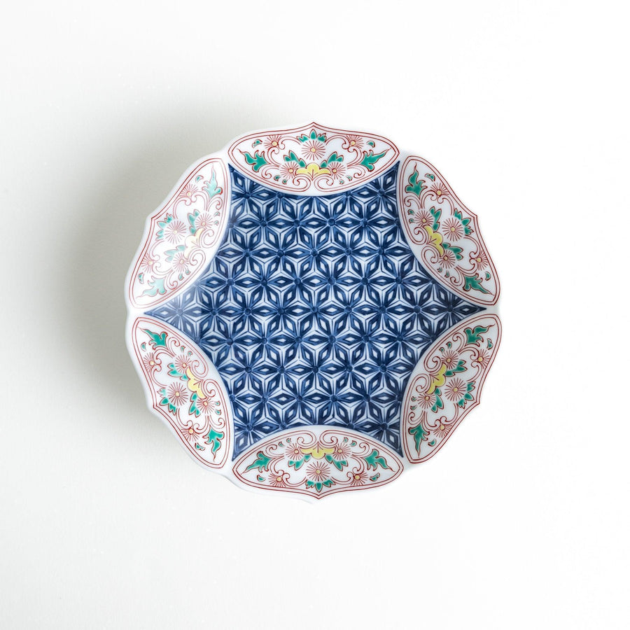 Blue dessert plate with geometric center and ornate floral rim in red green and gold with scalloped edge.