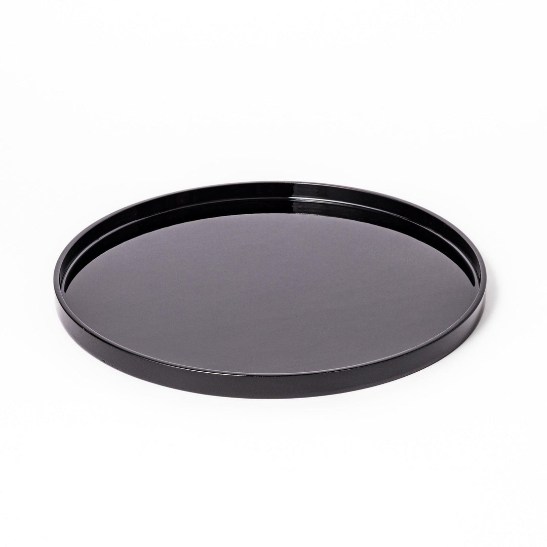 Glossy black Japanese wooden round tray with raised rim for serving tea or displaying tableware elegantly.