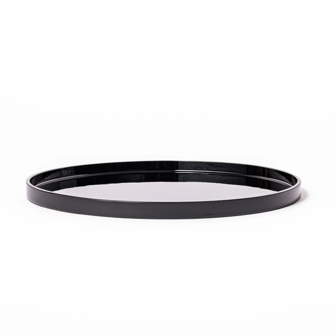 Glossy black Japanese wooden round tray with raised rim for serving tea or displaying tableware elegantly.