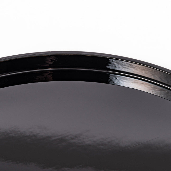 Glossy black Japanese wooden round tray with raised rim for serving tea or displaying tableware elegantly.