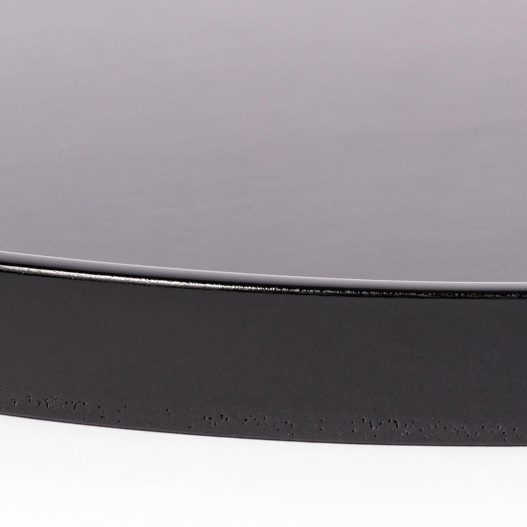 Glossy black Japanese wooden round tray with raised rim for serving tea or displaying tableware elegantly.