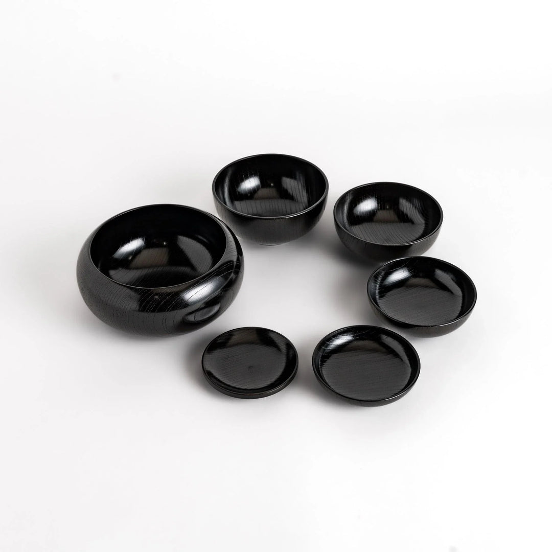 Black lacquer Oryoki bowl set with large serving bowl three medium bowls and small plates glossy finish.