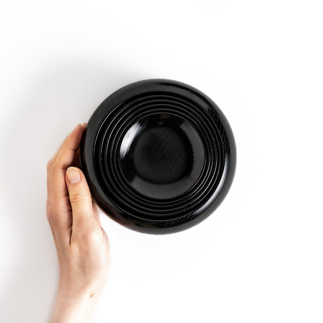 Black lacquer Oryoki bowl set with large serving bowl three medium bowls and small plates glossy finish.