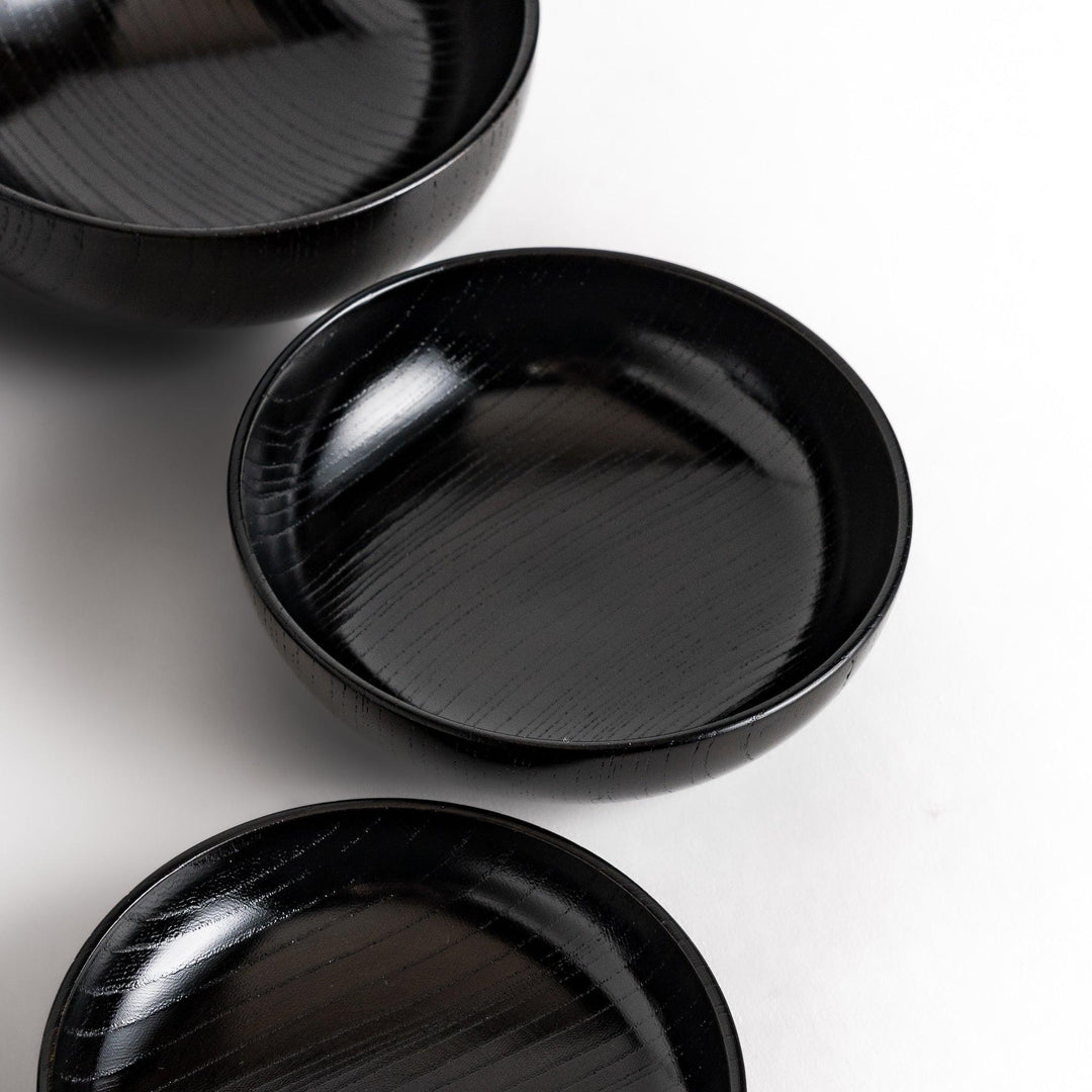Black lacquer Oryoki bowl set with large serving bowl three medium bowls and small plates glossy finish.