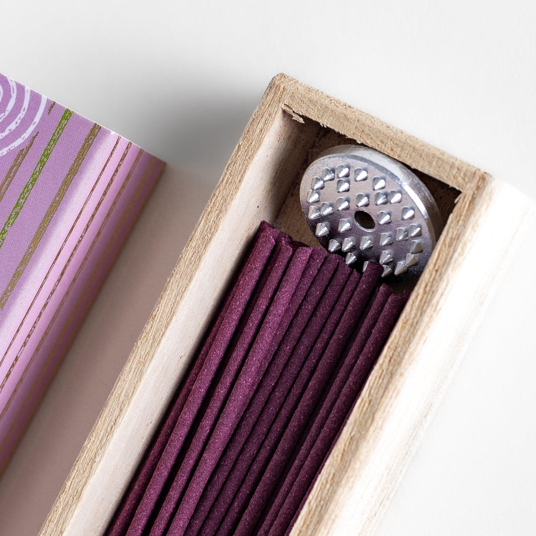 Japanese lavender incense in wooden box with purple sticks and white circle pattern on soft packaging.