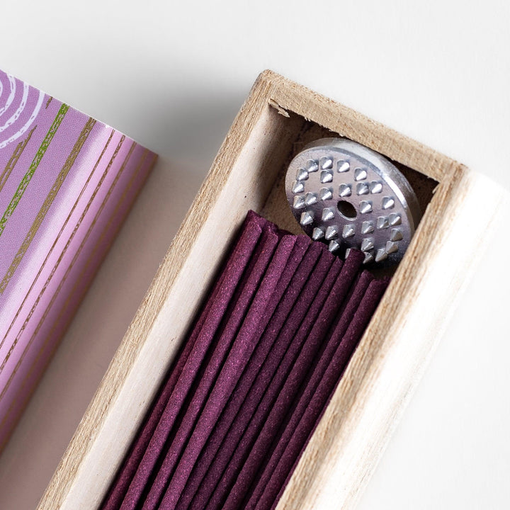 Japanese lavender incense in wooden box with purple sticks and white circle pattern on soft packaging.