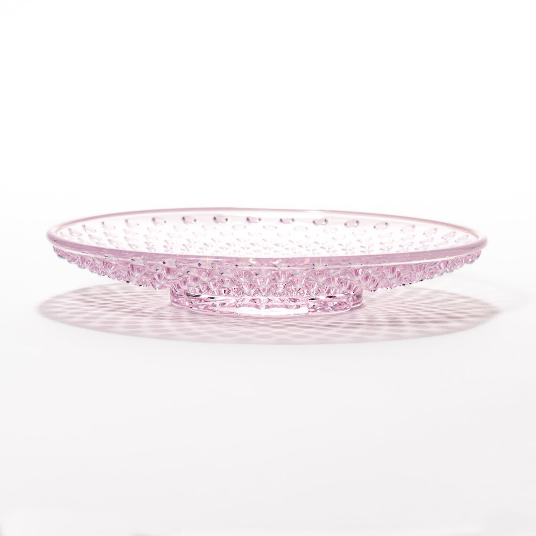 Pink glass dessert bowl and saucer with raised dot texture and starburst base, perfect for elegant sweets or fruit servings.