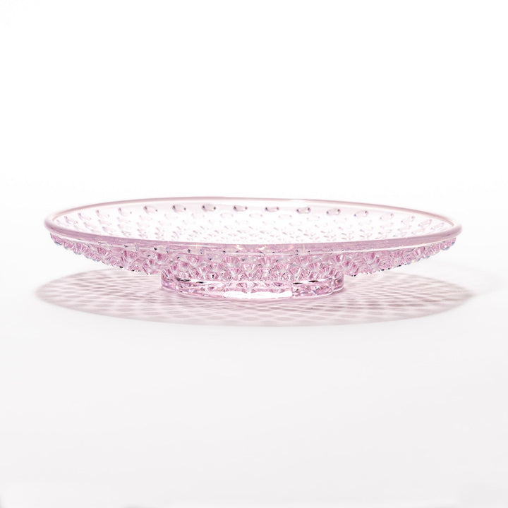 Pink glass dessert bowl and saucer with raised dot texture and starburst base, perfect for elegant sweets or fruit servings.