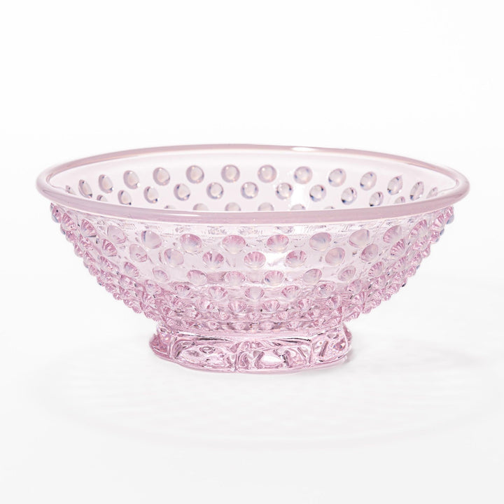 Pink glass dessert bowl and saucer with raised dot texture and starburst base, perfect for elegant sweets or fruit servings.