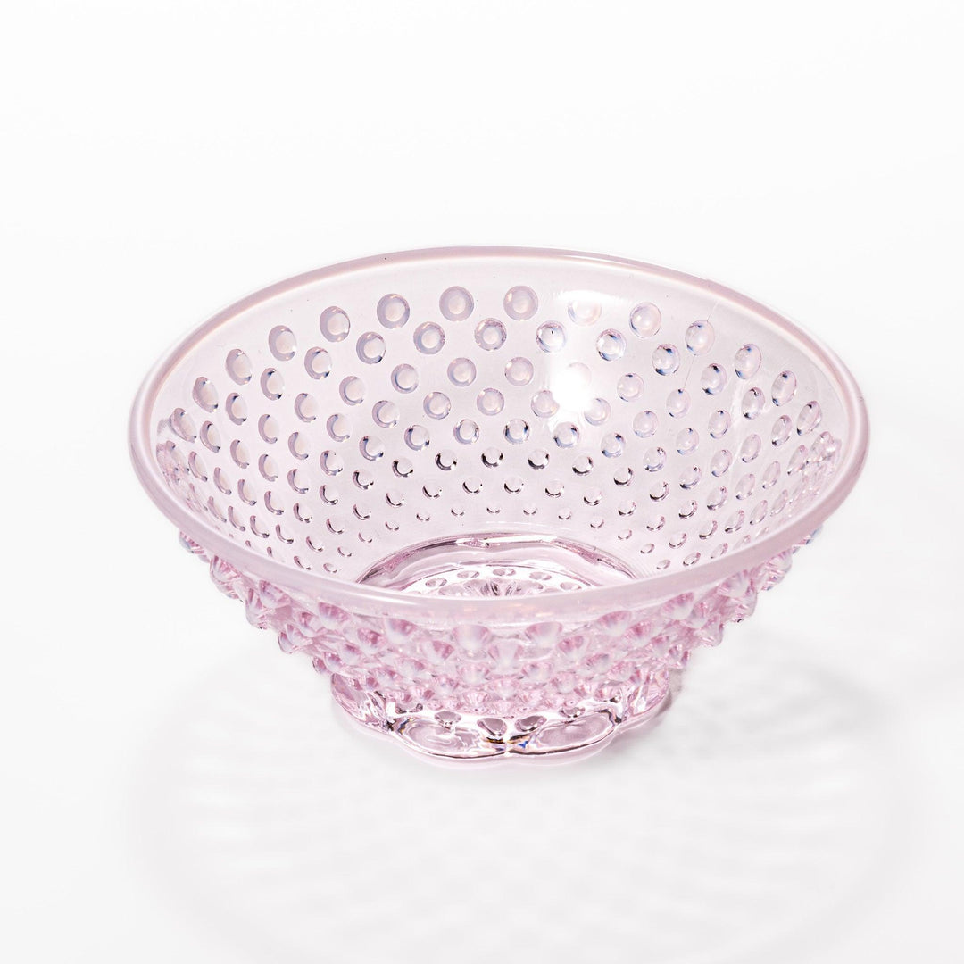 Pink glass dessert bowl and saucer with raised dot texture and starburst base, perfect for elegant sweets or fruit servings.