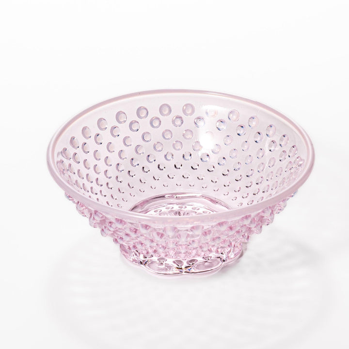 Pink glass dessert bowl and saucer with raised dot texture and starburst base, perfect for elegant sweets or fruit servings.