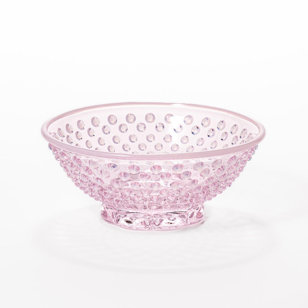 Pink glass dessert bowl and saucer with raised dot texture and starburst base, perfect for elegant sweets or fruit servings.