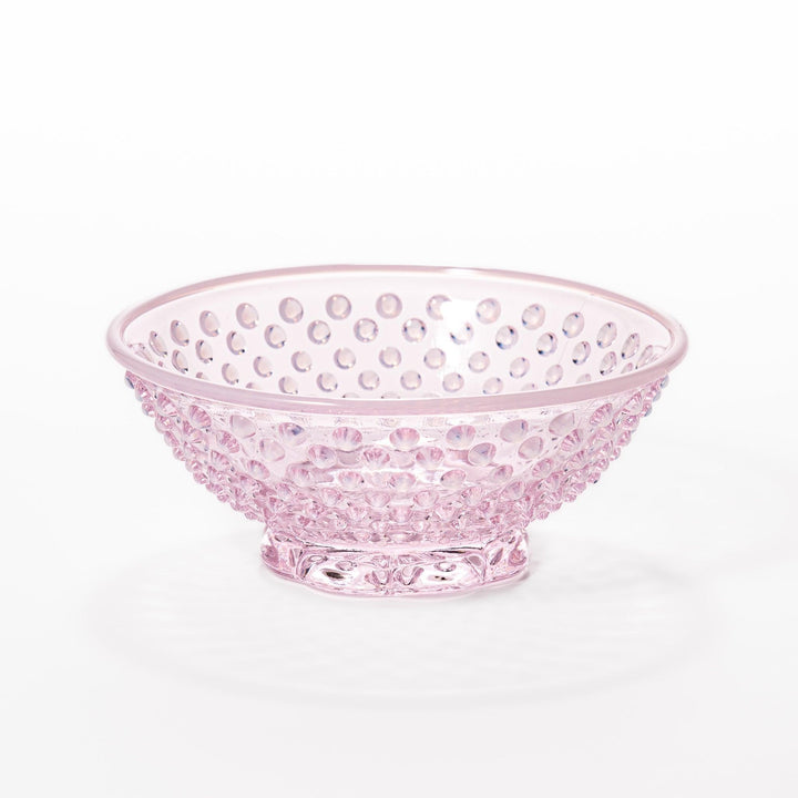 Pink glass dessert bowl and saucer with raised dot texture and starburst base, perfect for elegant sweets or fruit servings.