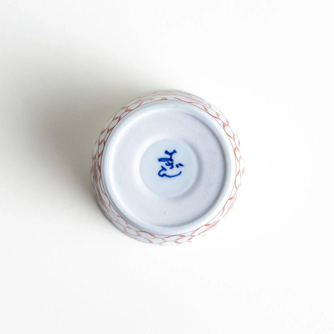 A condiment bowl decorated with a round floral motif, surrounded by a wavy lattice pattern, available in blue or red ink.