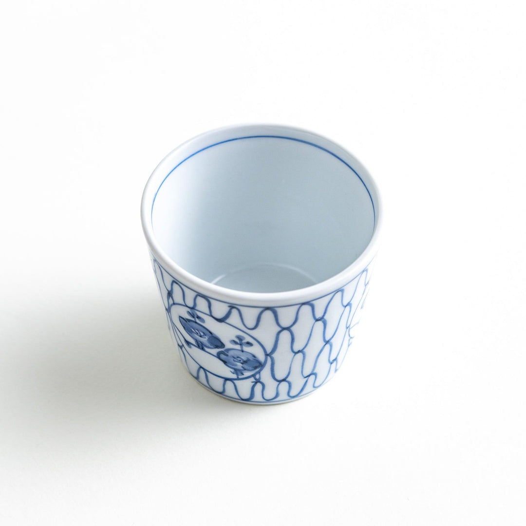 A condiment bowl decorated with a round floral motif, surrounded by a wavy lattice pattern, available in blue or red ink.
