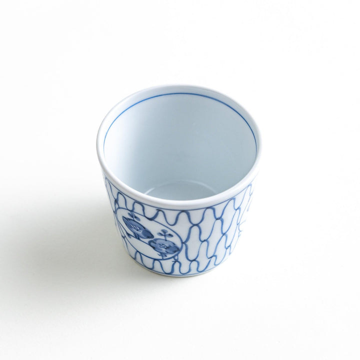 A condiment bowl decorated with a round floral motif, surrounded by a wavy lattice pattern, available in blue or red ink.