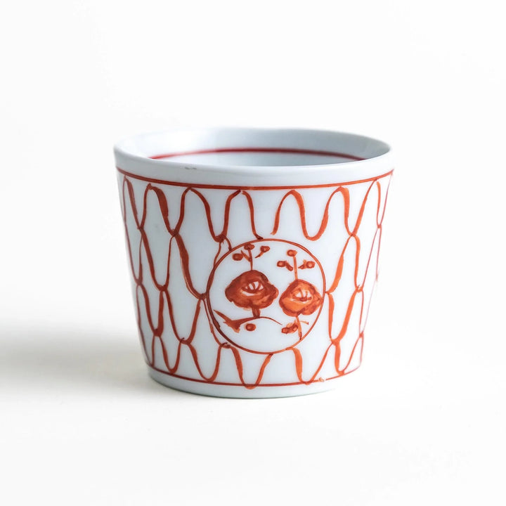 A condiment bowl decorated with a round floral motif, surrounded by a wavy lattice pattern, available in blue or red ink.