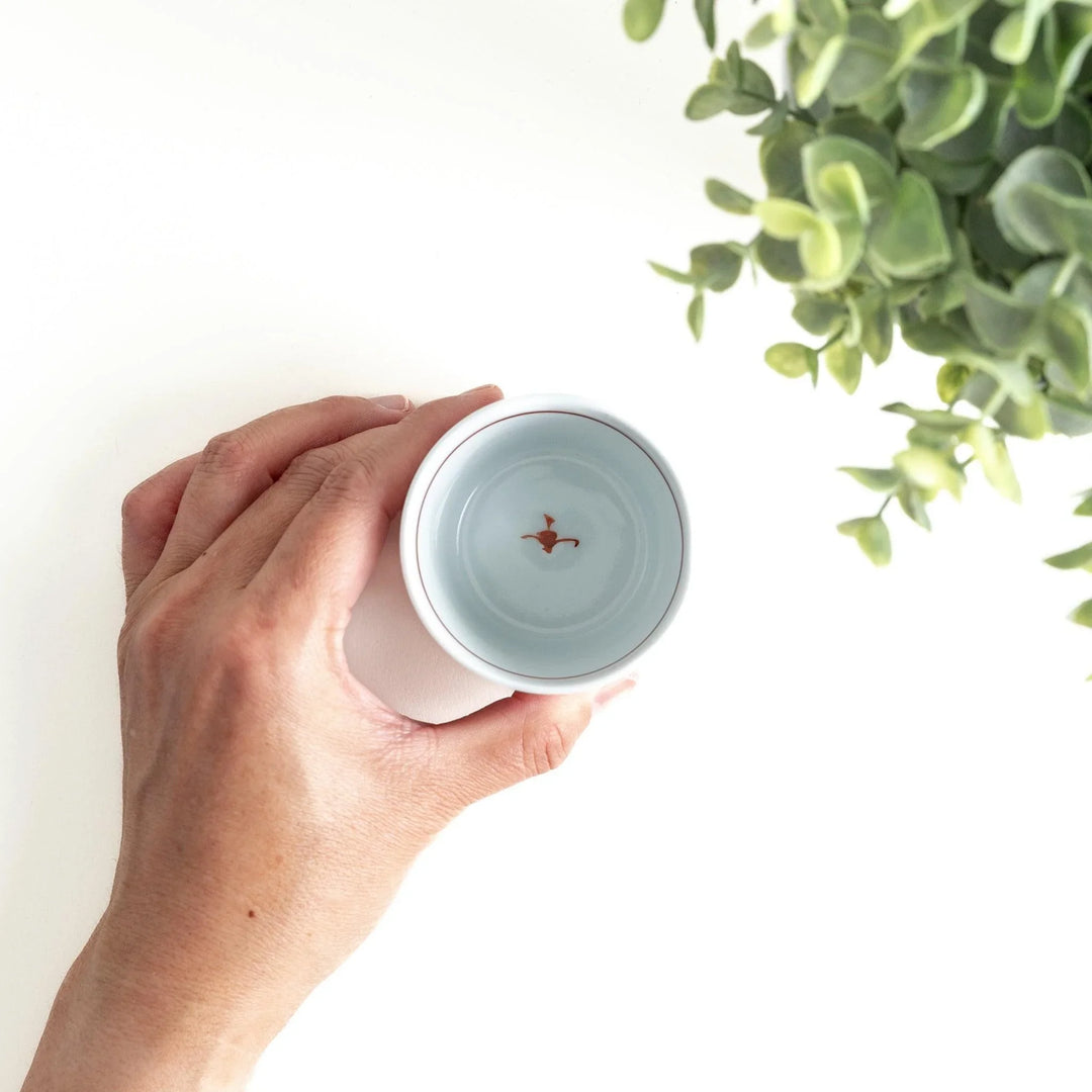 A condiment bowl decorated with a round floral motif, surrounded by a wavy lattice pattern, available in blue or red ink.