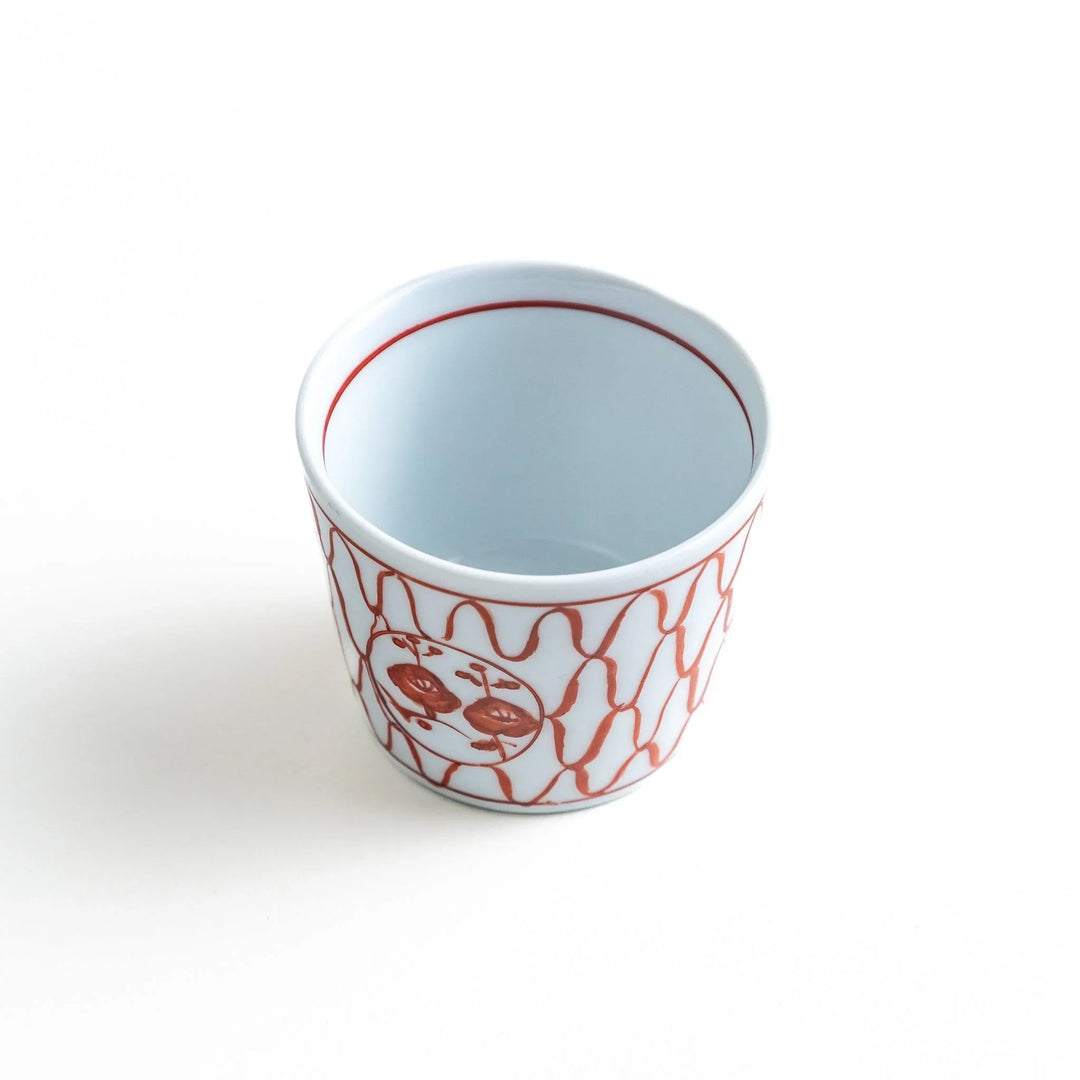 A condiment bowl decorated with a round floral motif, surrounded by a wavy lattice pattern, available in blue or red ink.