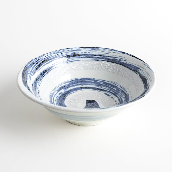 A large white bowl with a blue swirl pattern on the interior, featuring a smooth finish.