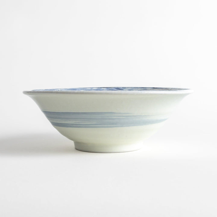 A large white bowl with a blue swirl pattern on the interior, featuring a smooth finish.