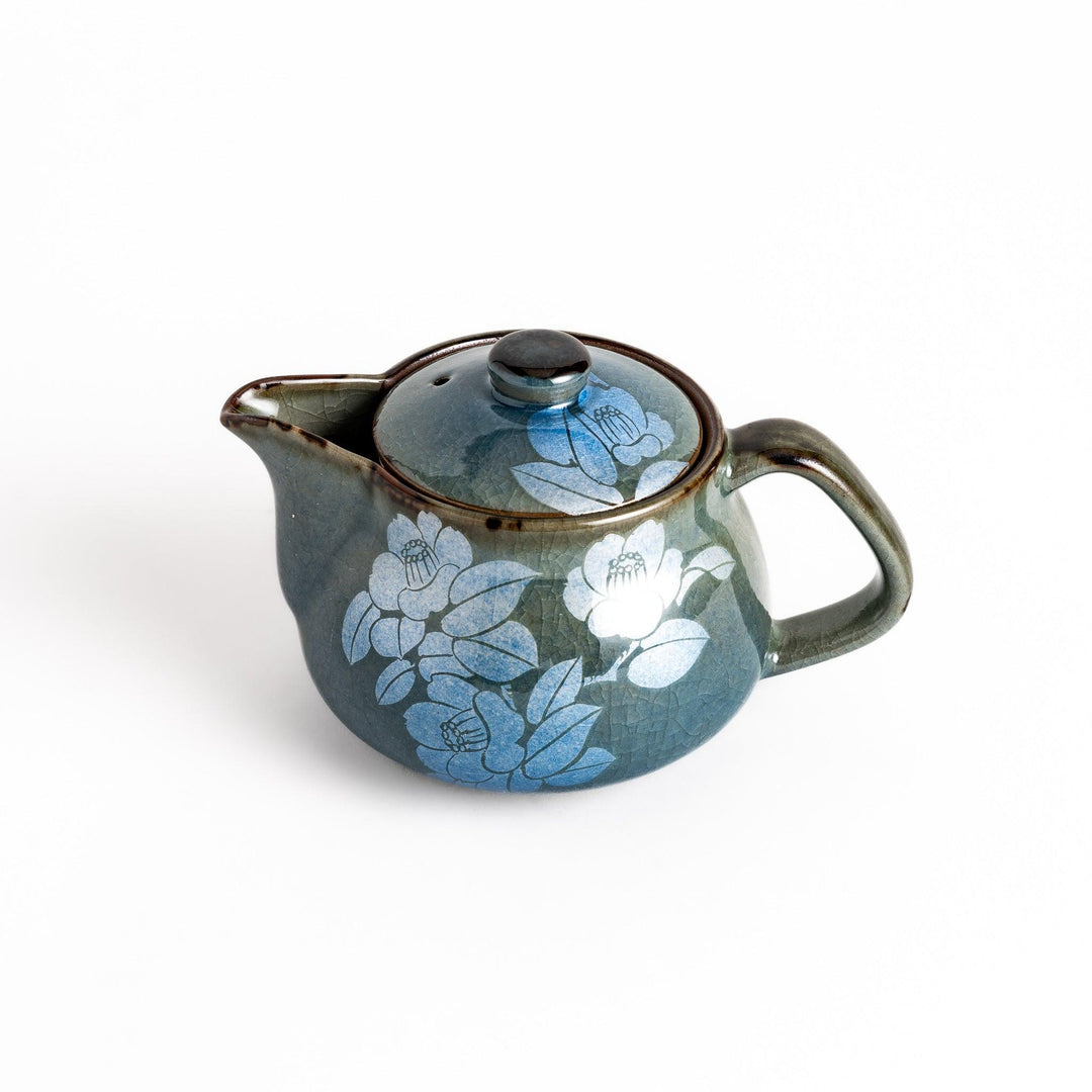Stylish blue ceramic teapot with a delicate white camellia flower pattern. Perfect for enjoying your favorite tea.