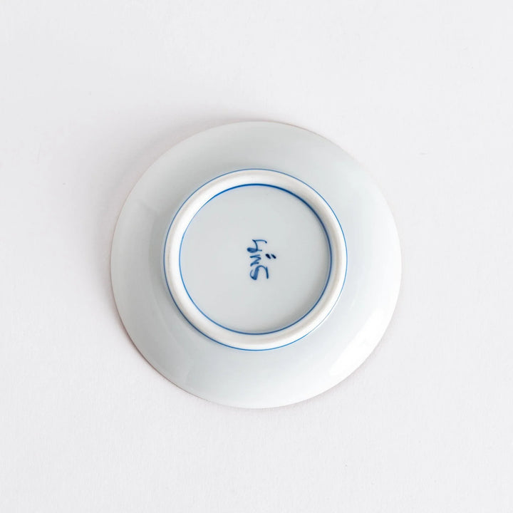 Bottom view of a sauce dish with a maker's mark, highlighting its smooth finish and quality craftsmanship.