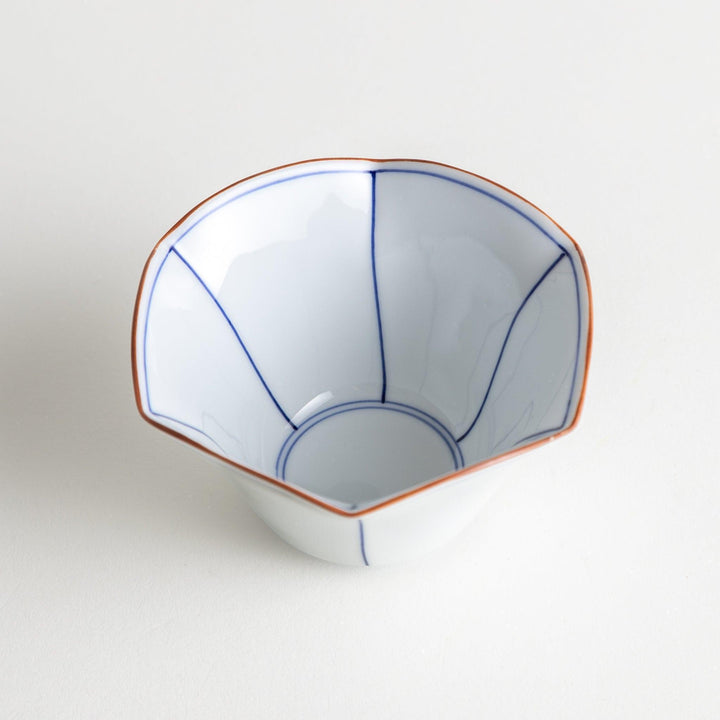 A white ceramic bowl with a flared, scalloped edge and simple blue line detailing.