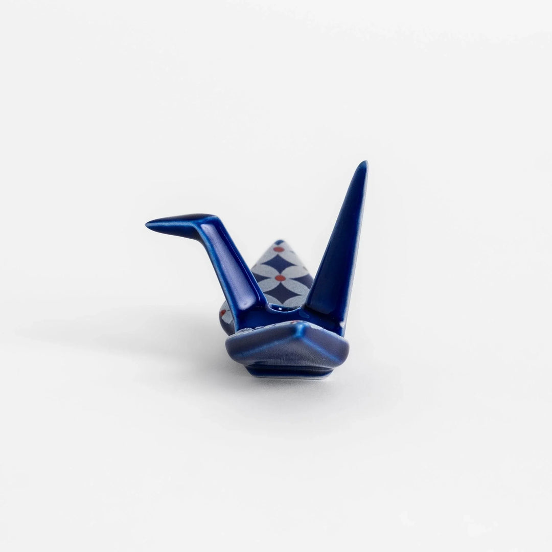 Blue origami crane incense holder with silver and red geometric pattern adding artistic charm to your space.