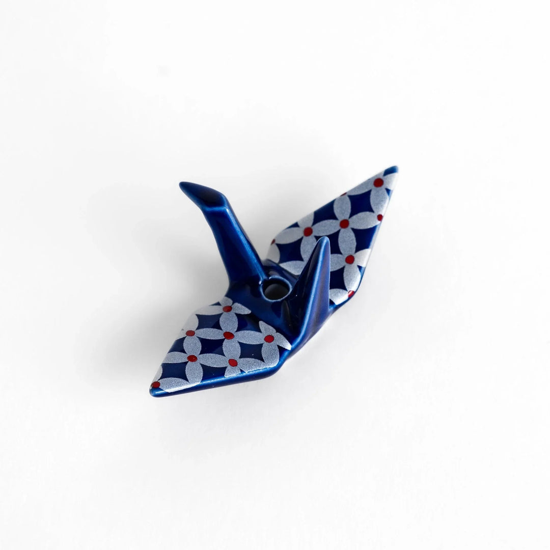 Blue origami crane incense holder with a geometric silver and red pattern, adding a unique, artistic touch to your space.