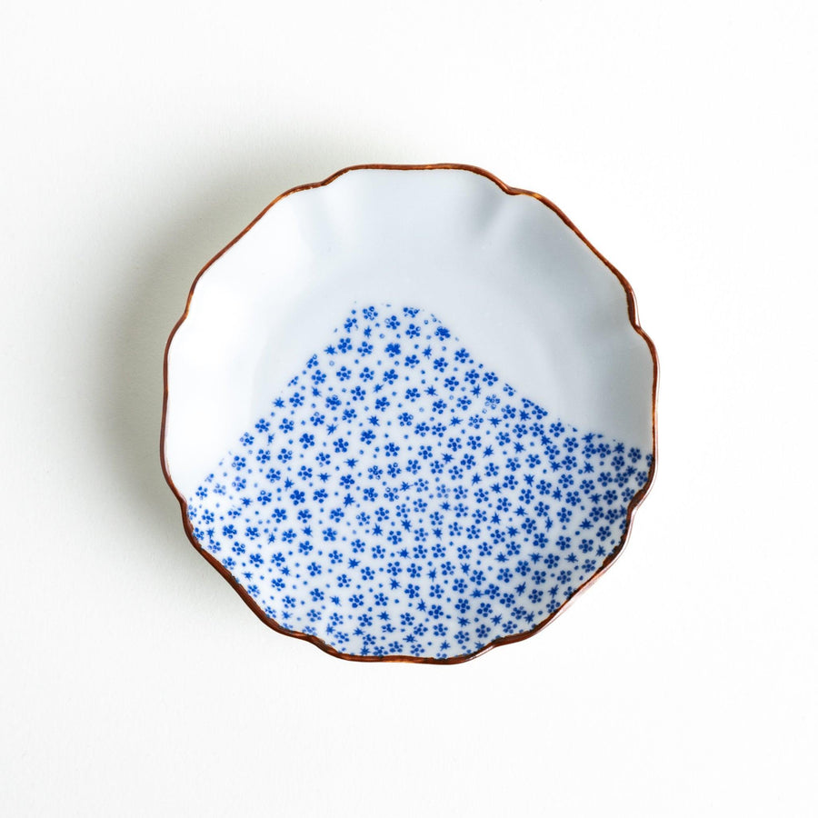 Small Japanese dish with soft blue Mount Fuji pattern and white section forming abstract mountain design.