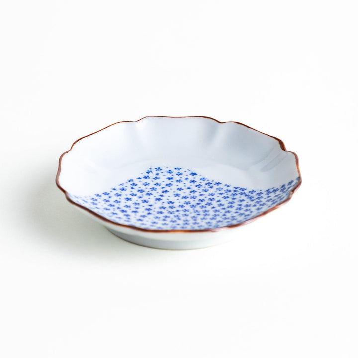 Small Japanese dish with soft blue Mount Fuji pattern and white section forming abstract mountain design.