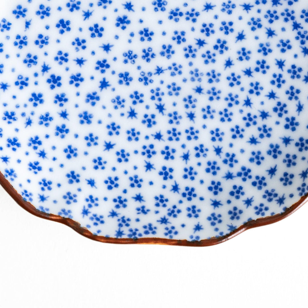 Small Japanese dish with soft blue Mount Fuji pattern and white section forming abstract mountain design.