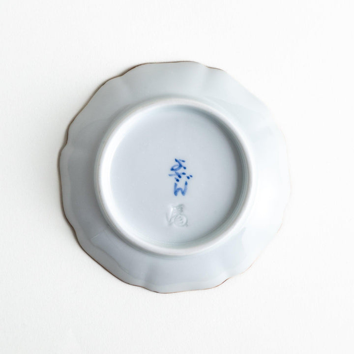 Small Japanese dish with soft blue Mount Fuji pattern and white section forming abstract mountain design.