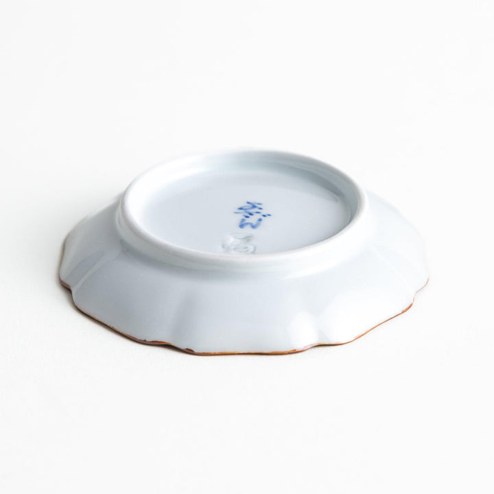 Small Japanese dish with soft blue Mount Fuji pattern and white section forming abstract mountain design.