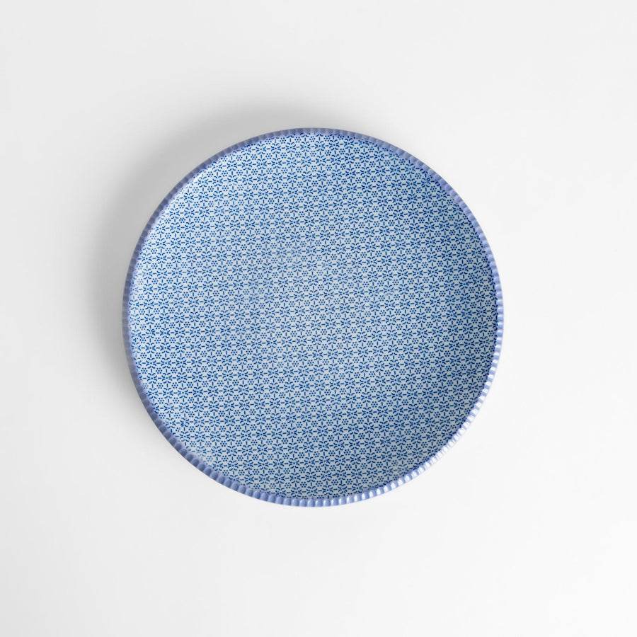 Blue and white floral patterned Japanese dinner plate with subtle striped rim for refined dining style.
