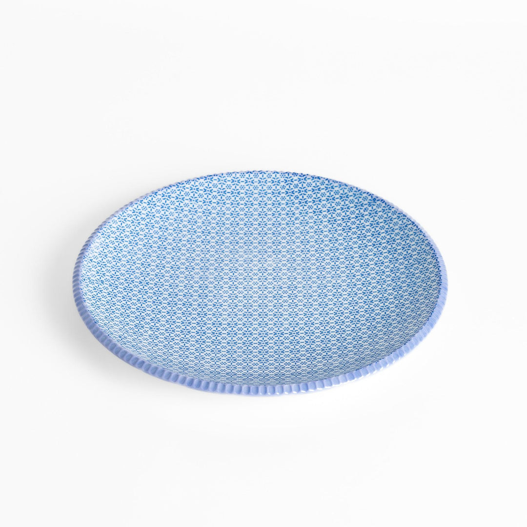 Blue and white floral patterned Japanese dinner plate with subtle striped rim for refined dining style.