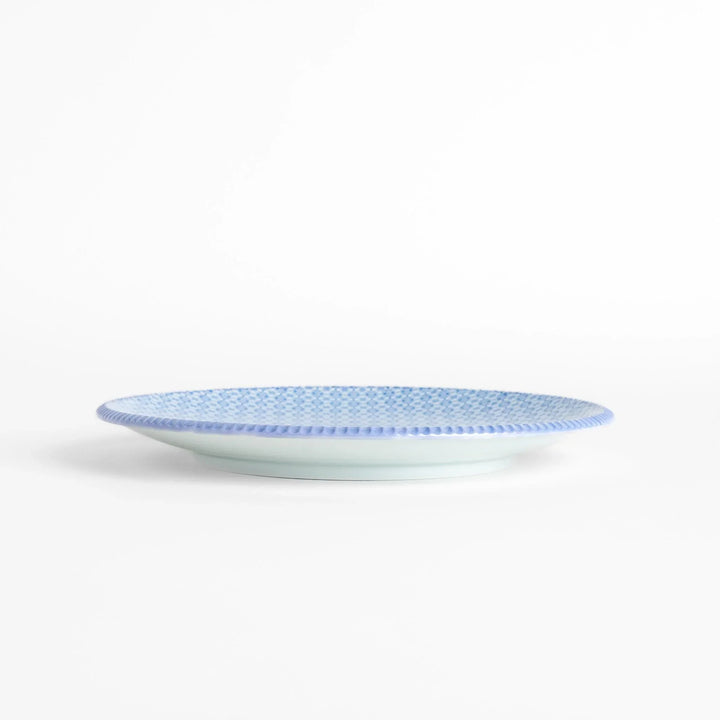 Blue and white floral patterned Japanese dinner plate with subtle striped rim for refined dining style.