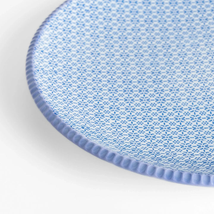 Blue and white floral patterned Japanese dinner plate with subtle striped rim for refined dining style.